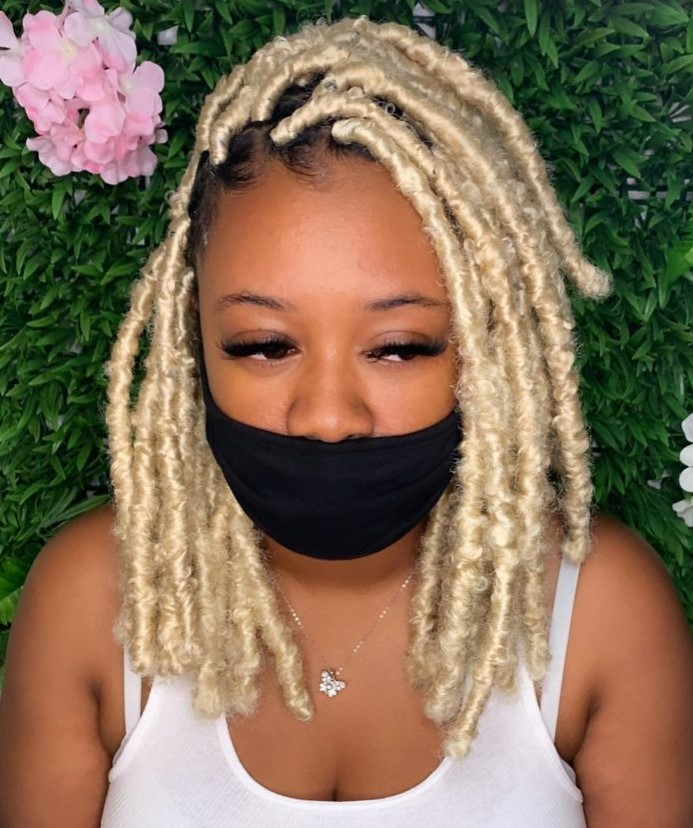 A lady with blonde faux locs