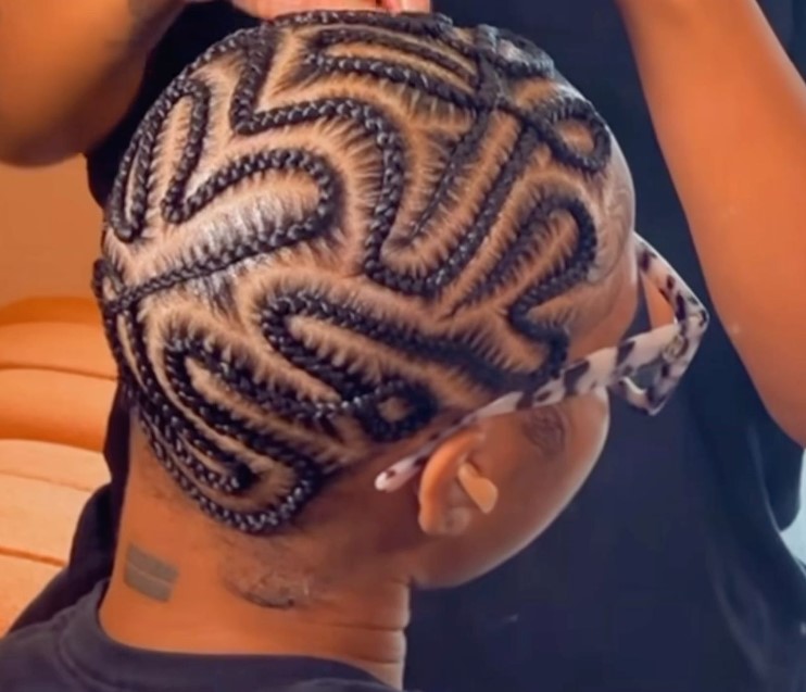 braided bald head hairtyle with tribal designs